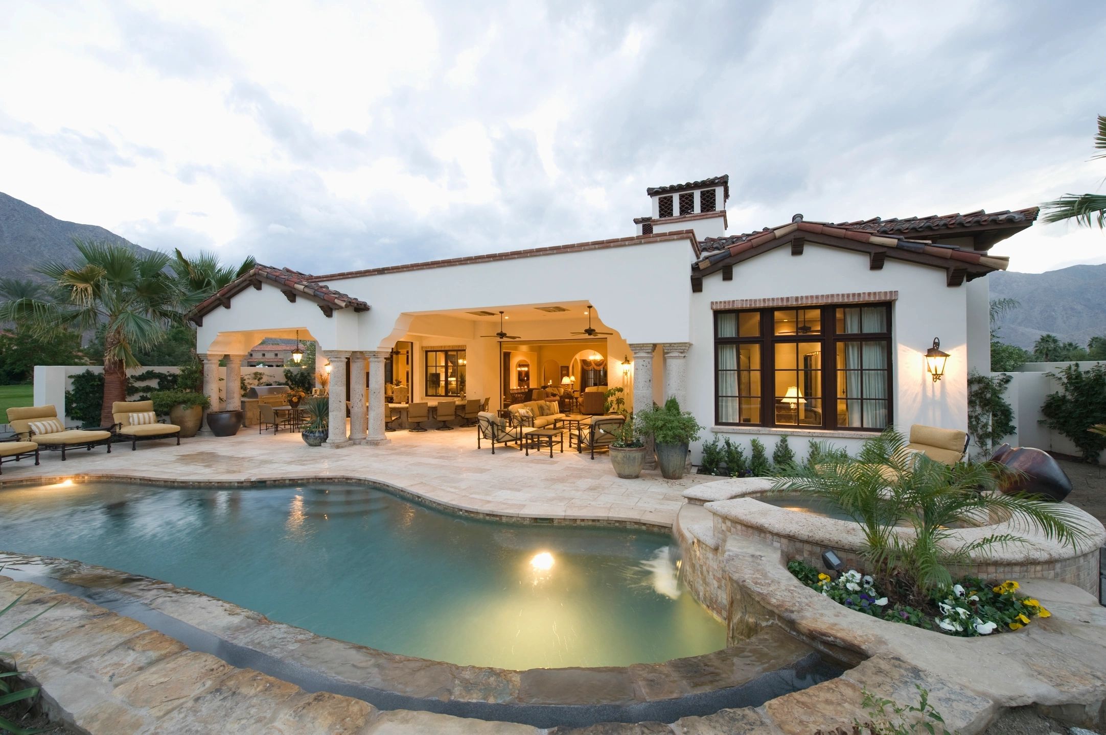 Spanish style home backyard with a pool